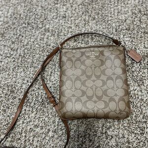 Coach Brown Crossbody Bag with Monogram Pattern and Leather Strap